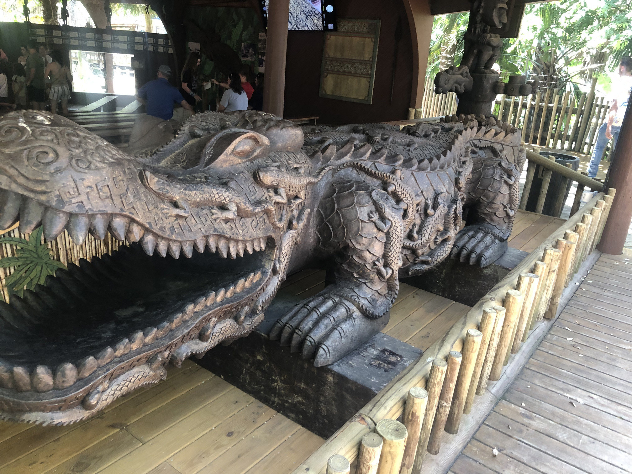 An huge and intricately carved wooden alligator.